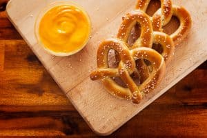 Three delicious pretzels on the chopping board, Can Hamsters Eat Pretzels?